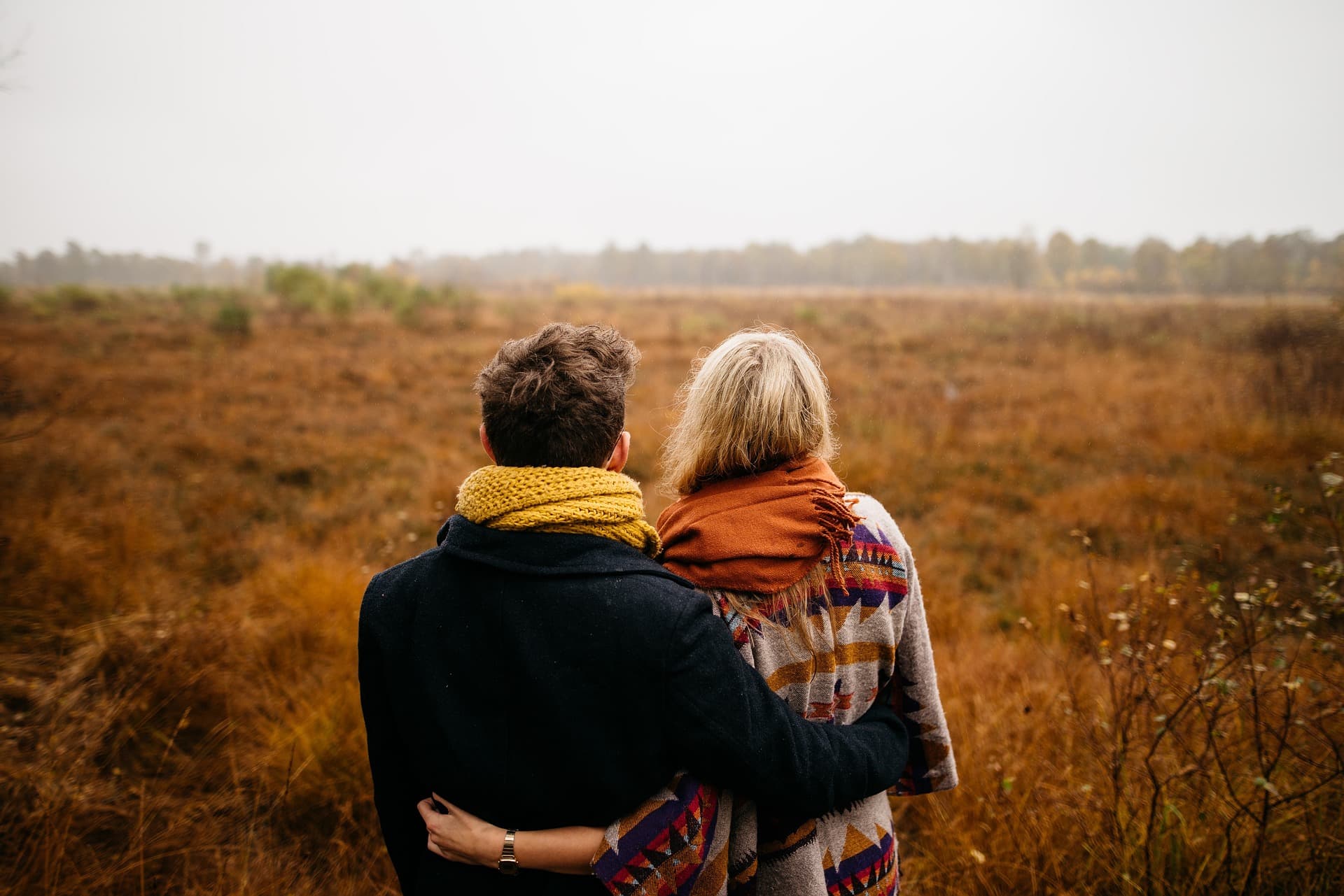 Happy couple hugging and facing away